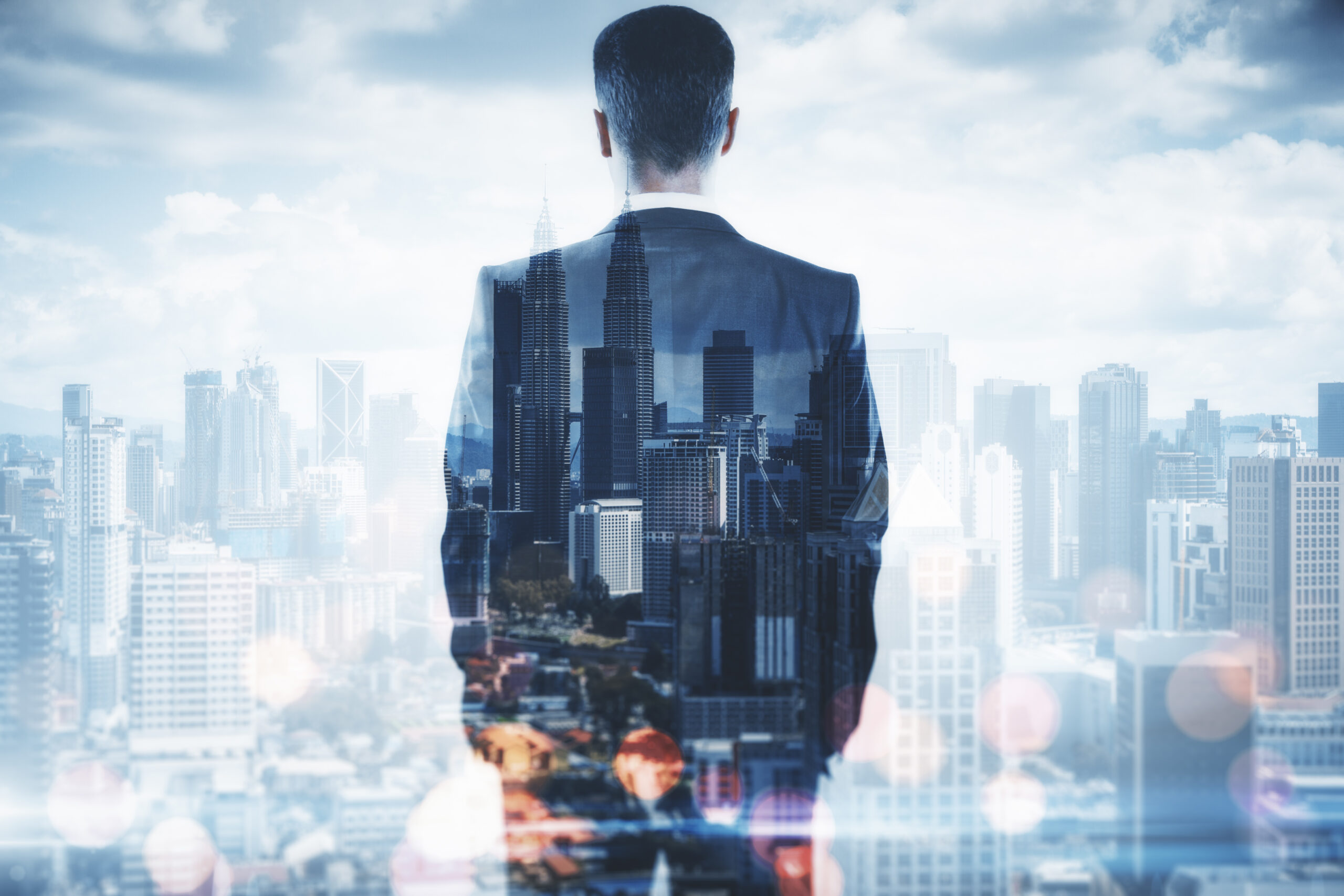 Back view of businessman on blurry bokeh city background. Success and confidence concept. Double exposure